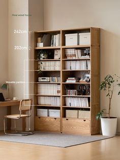 a room with a book shelf, desk and chair in the corner next to a potted plant