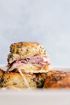 two ham and cheese bagels stacked on top of each other with sprinkles