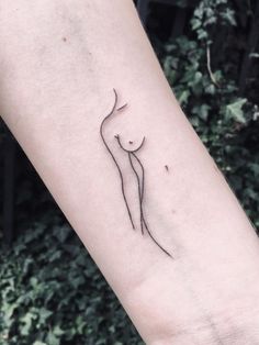 a woman's arm with a small tattoo design on the left side of it