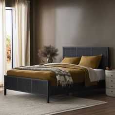 a bed room with a neatly made bed and two nightstands next to each other