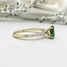 This beautiful ring is made from genuine 925 sterling silver with yellow gold plating. Ring details- -The Main stone is an oval cut 8mm by 6mm Lab Created Nano Emerald Stone -Side stones are 1.2 Round simulated diamonds -Ring is casted in solid 925 sterling silver with yellow gold plating (rose gold and rhodium plated also available, please check the drop down menu for more options) -The Total face height of the ring measures 8mms and the band width measures 2mms -Each ring is handmade and made Gold Emerald Wedding Ring With Oval Cabochon, Elegant Gold Emerald Ring Oval Cabochon, Yellow Gold Oval Cabochon Emerald Ring, 14k Yellow Gold Emerald Ring Oval Cabochon, Oval Emerald Ring In Gold-toned Sterling Silver, Oval Emerald Engagement Ring, Diamond Art Deco Ring, Tiffany Wedding Rings, Silver Wedding Ring