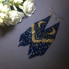 "These dark blue gold beaded earrings pair amazingly with any outfit, dressy or casual. They are made of high-quality Czech colored beads with steel . Colors: bdark blue, gold Length: 4.7 inches (12 cm) Width: 1.1 inches (3 cm) Materials: Czech \"Preciosa\" beads Durable synthetic thread medical steel" Bohemian Blue Earrings With Gold Beads, Blue Beaded Earrings With Gold Beads For Festivals, Elegant Gold Beaded Earrings For Festival, Handmade Gold Beaded Earrings For Evening, Party Blue Beaded Earrings With Gold Beads, Blue Bohemian Chandelier Earrings For Party, Handmade Blue Evening Earrings, Beaded Moon Earrings, Blue Gold Earrings