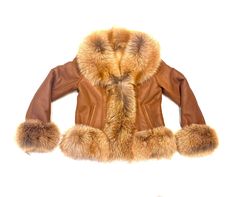 material: fox fur, lambskin, shearling style: shearling color: whiskey Classic Sheepskin Coat With Faux Fur Trim, Classic Sheepskin Fur Coat With Faux Fur Trim, Luxury Sheepskin Fur Coat With Faux Fur Lining, Mink Colored Shearling Fur Coat With Faux Fur Trim, Luxury Sheepskin Fur Coat With Faux Fur Trim, Luxury Shearling Fur Coat With Faux Fur Trim, Fitted Brown Sheepskin Fur Coat, Brown Faux Fur Coat With Feather Trim, Luxury Brown Fur Coat