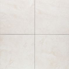 a white tile wall with four squares in it