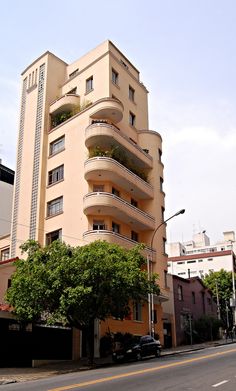 an apartment building with balconies and plants on the top floor is shown in this photo