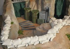 there is a fake model of a waterfall in the rock garden with rocks and plants