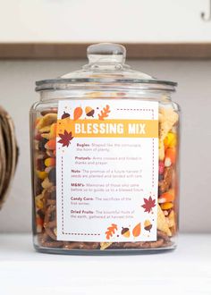 a glass jar filled with candy corn sitting on top of a counter