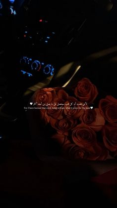 a bouquet of roses sitting in the center of a car dashboard with lights on and an illuminated dash board