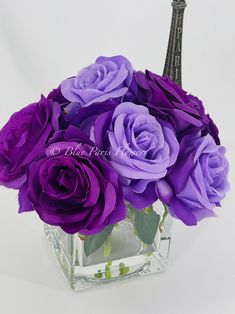 purple roses in a square glass vase with the eiffel tower in the background