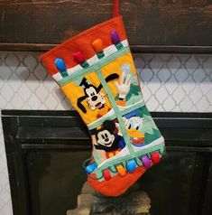 mickey mouse christmas stocking hanging on the fireplace