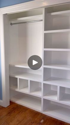 an empty white bookcase with shelves and doors in a room that is painted blue