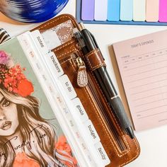 a notepad, pen and notebook on a desk