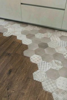 the kitchen floor has been painted with different colors and patterns, including hexagonal tiles