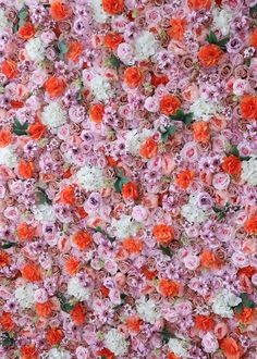 a wall covered in lots of pink and orange flowers