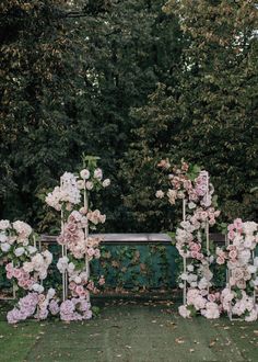 an outdoor ceremony setup with flowers and greenery