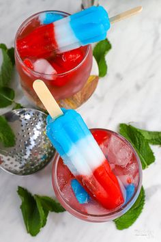 two glasses filled with red, white and blue popsicles