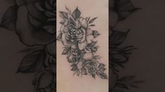 a black and white rose tattoo on the arm