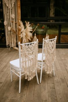 two white chairs sitting on top of a wooden floor