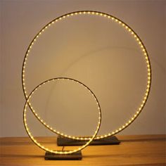 two circular lights sitting on top of a wooden table