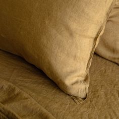 two brown pillows sitting on top of a bed