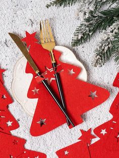 a red christmas tree place setting with forks and knife