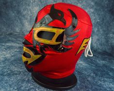 a red mask with yellow and black designs on it