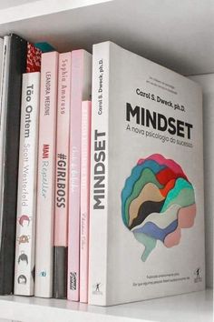 a book shelf with several books on it, including one in the shape of a brain