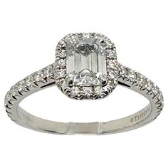 an engagement ring with diamonds on the sides and a square cut diamond in the center