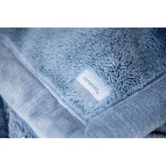 a close up of a blue blanket with a label on the front and back of it