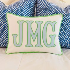 two pillows with the letter jmg on them