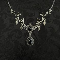 "This enchanting moon elf necklace features richly detailed antiqued silver tone filigree crescent, intricate leafy branches and elegant scroll drop accents. Its captivating design is adorned with dazzling jet black glass crystals. Decorated portion is 4 1/2\" wide and 2 1/2\" tall in the very center.  Necklace length is adjustable with soldered stainless steel cable chain, lobster clasp and extender. If you would like a different length, please send us a message. Matching headpiece, pendant and earrings are listed separately in our store. If you don't see items with a color you want, feel free to ask about availability." Silver Gothic Necklaces For Fantasy Events, Silver Necklace For Fantasy Events, Silver Gothic Jewelry For Fantasy Events, Medieval Style Silver Necklaces For Fantasy Events, Mystical Silver Jewelry With Intricate Design, Fantasy Silver Jewelry With Moon Charm, Elegant Silver Jewelry For Fantasy Events, Gothic Silver Crescent Necklace, Gothic Metal Jewelry With Moon Phase Detail