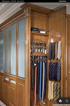 a closet with ties hanging on the wall