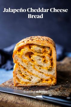 a cheesy bread sandwich cut in half on a cutting board with the words jalapeno cheddar cheese bread