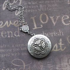 Silver Locket Necklace, Celtic Jewelry, Photo Picture Locket, Locket For Her, Celtic Wedding, Trinity Necklace, Mother of Three, Locket Gift This enchanted necklace features a beautiful locket adorned with an ornate silver filigree cabochon and rosary style connector. The chain measures 18 inches long and is secured with a lobster clasp. The locket is 1 and 1/4 inches tall and has space for two photos or anything else you choose to put inside. All plated in silver with an oxidized finish. Very h Metal Locket Necklace For Wedding, Metal Pendant Locket Necklace For Wedding, Classic Locket Jewelry For Wedding, Classic Wedding Locket Jewelry, Antique Engraved Jewelry For Marriage, Ornate Metal Jewelry For Wedding, Medallion Locket Necklace With Adjustable Chain For Weddings, Classic Locket Necklace For Wedding, Silver Locket Necklace With Adjustable Chain For Wedding