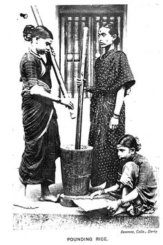 an old photo of two women standing next to a bucket with baseball bats in it