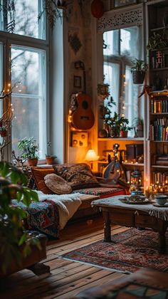 a living room filled with lots of furniture next to a window covered in christmas lights