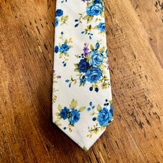 Beautiful floral tie in a bright white and blue. This 100% cotton tie would look so lovely at a spring or summer wedding, either for the groom, groomsmen, ushers or wedding guests. The fabric is soft to the touch and the colours look amazing together. Material: 100% viscose Size: 145cm x 6cm This item will be hand gift wrapped before posting. Elegant Blue Cotton Ties, Elegant Blue Cotton Suit And Tie Accessories, Summer Formal Cotton Suit Accessories, Formal Cotton Suit And Tie Accessories For Summer, White Cotton Ties For Formal Occasions, Blue Cotton Tie For Formal Occasions, Cotton Ties For Weddings, Fitted Cotton Ties For Wedding, Spring Cotton Ties For Black Tie Events