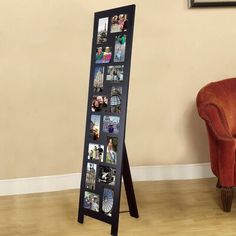 a chair sitting in front of a large black framed photo on a wooden floor next to a wall