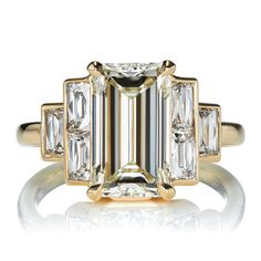 an emerald cut diamond ring with three baguets