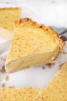 a piece of pie on a white plate with a fork in it and another slice missing