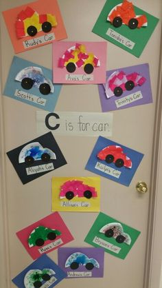 a door decorated with paper cut outs and pictures of cars on the front, which say c is for car