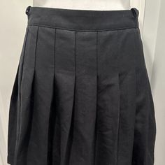 Uo Urban Outfitters Black Pleated Mini Skirt Side Zipper Nwt Size Small This Is Literally The Perfect "Little Black Skirt"!! This Adorable Skirt Is Brand New With Tags - Never Worn - The Pleats Do Need A Little Ironing If You Like Perfect Pleats!! The Skirt Is In Excellent Condition - Side Zipper And 2 Small Belt Loops On Either Side. Skirt Is A Size Small - Waist Measures 26" And From Waist To Hem The Length Is 15". 66% Polyester, 32% Viscose, 2% Elasthanne -- Machine Washable But Line Dry!! Urban Outfitters Black Short Length Bottoms, Black Skirt For School, School Black Pleated Skirt Bottoms, Black High Waist School Skirt, High Waist Black Skirt For School, Black Short Skirt For School, High Waist School Uniform Mini Skirt, High Waist Black Skort For School, Black High Waist Lined Tennis Skirt