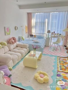 a living room filled with lots of furniture next to a bed and desk in front of a window