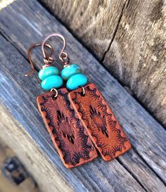 These earrings feature a hand stamped southwestern design and are dyed a medium brown and are topped with genuine Kingman mine turquoise beads...earrings hang from hand formed copper French style ear wires... Big enough to be seen yet super lightweight!  You'll reach for these earrings day after day.  *Please be aware of and allow for slight natural color variations in the turquoise.   Do you have sensitive ears?  I offer titanium ear wires and am happy to replace them on these earrings.  Simply Artisan Stamped Brown Jewelry, Southwestern Hand Tooled Earrings For Gift, Southwestern Hand Tooled Earrings As Gift, Southwestern Hand-tooled Earrings As Gift, Hand Tooled Southwestern Earrings For Gift, Bohemian Turquoise Hand-tooled Earrings, Brown Stamped Jewelry For Festivals, Stamped Brown Jewelry For Festival, Turquoise Bead Earrings