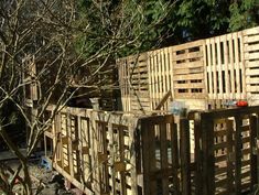 a wooden fence is being constructed in the woods