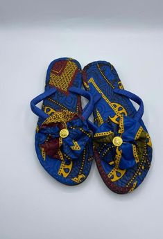 African Print/Ankara SlippersPamper your feet with a playful slipper featuring bow/rosette. Handmade from 100% African wax cotton, This stylish slipper is comfortable, stylish and durable guaranteed to last you for years. Definitely a "must-have" piece. It makes a great gift too! Comes in different colours and sizes, please check our other listings. p.s. Some comes as rosette and others as now will randomly be picked. Due to the pattern of fabric there may be slight variation. Blue Ankara, African Crafts, Printed Flip Flops, Rope Necklace, Tory Burch Miller Sandal, Boys Clothing, Waxed Cotton, African Print, Womens Flip Flop