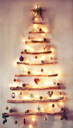 a wooden christmas tree with lights on it