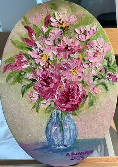 a painting of pink flowers in a blue vase