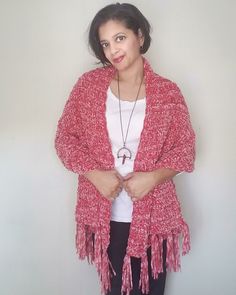 a woman standing in front of a white wall