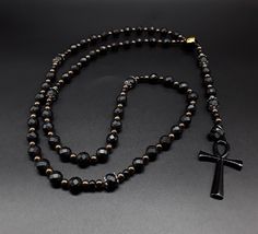 The Catholic Yin and Yang 5 Decade Ankh Rosary is an exclusive, special and designer Rosary. It has been created for individuals that seek to stand above and to differentiate themselves from the rest. In regards to the beads. The beads are triple-A high quality (polygonic) Black Onyx, pure Hematite and a Yin and Yang central bead (all beads are completely cleansed and purified). Second, its cross: made of a black unbreakable stainless steel Ankh Cross symbolizing the eternal life. Third, the Ros Black Faceted Spiritual Beads, Ankh Rosary, Words To Describe People, Gold Rosary Necklace, Ankh Cross, Gold Rosary, Michael Johnson, Rosary Bracelet, Rosary Necklace